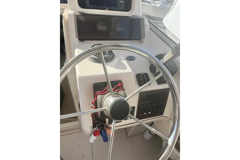 Slide: The Image of 1999 Grady-White Islander 268 boat steering wheel and control panel. - 22