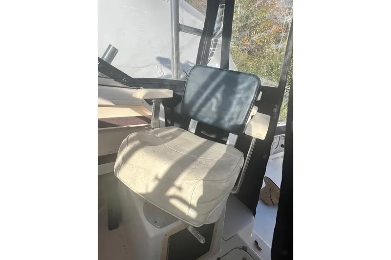 Slide: The Image of Captain's chair on 1999 Grady-White Islander 268 boat, with sunlight and shadows. - 23