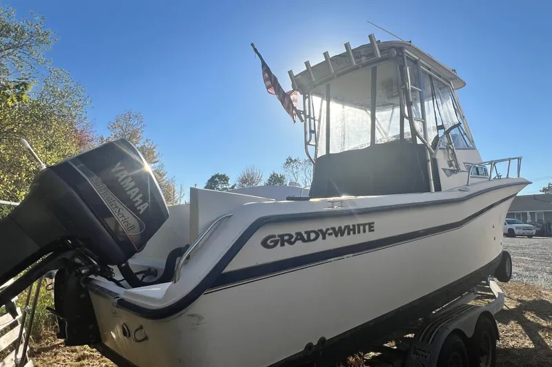 Slide: The Image of 1999 Grady-White Islander 268 boat with Yamaha outboard motor, parked on a trailer. - 6