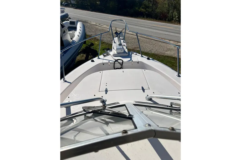 Slide: The Image of 1999 Grady-White Islander 268 boat deck view, featuring bow railings and windshield. - 7