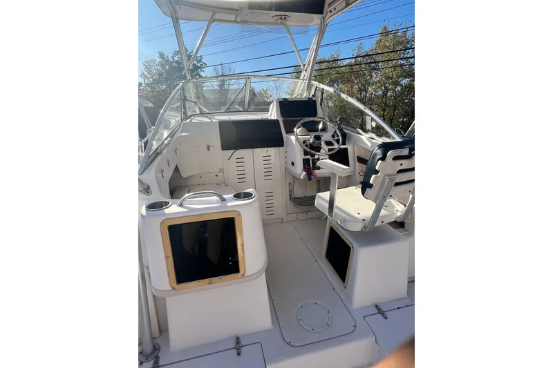 Slide: The Image of 1999 Grady-White Islander 268 boat cockpit with steering wheel and seating. - 8