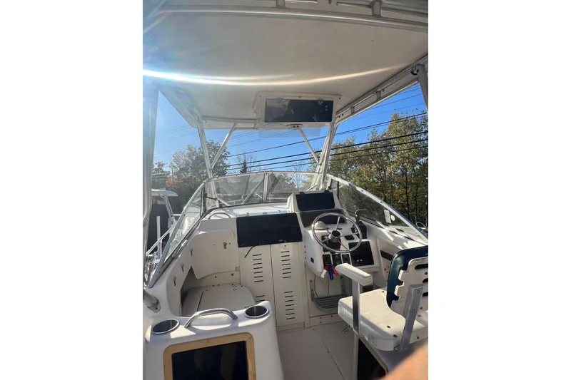 Slide: The Image of 1999 Grady-White Islander 268 boat cockpit with steering wheel and controls. - 9