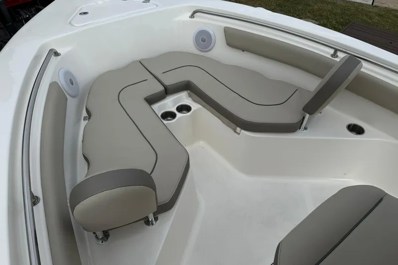 Slide: The Image of 2022 Key West 203 FS boat interior with beige seating and cup holders. - 16