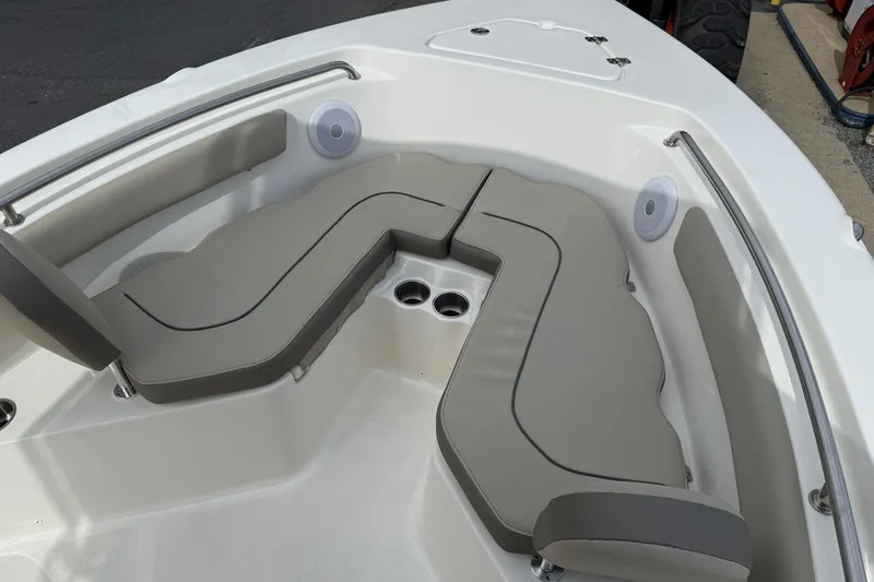 Slide: The Image of 2022 Key West 203 FS boat interior with cushioned seating and cup holders. - 17