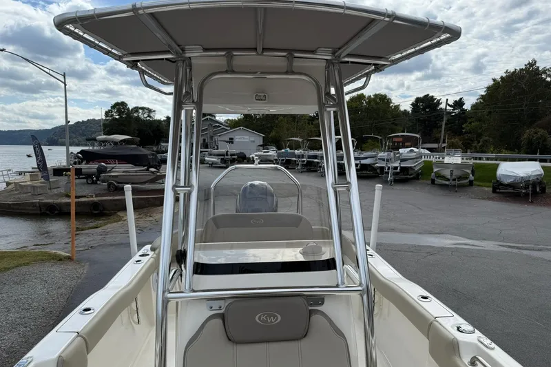 Slide: The Image of 2022 Key West 203 FS boat with T-top, docked near a scenic waterfront. - 18