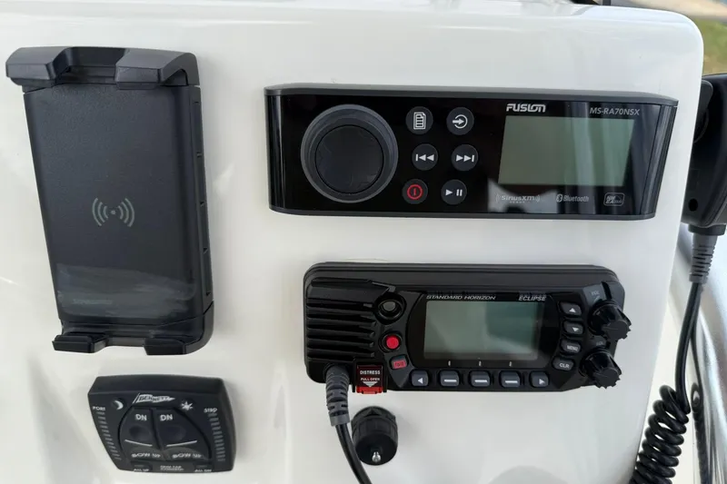Slide: The Image of Control panel of a 2022 Key West 203 FS boat with radio and navigation equipment. - 19