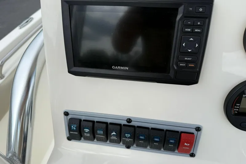 Slide: The Image of 2022 Key West 203 FS boat dashboard with Garmin display and control switches. - 21