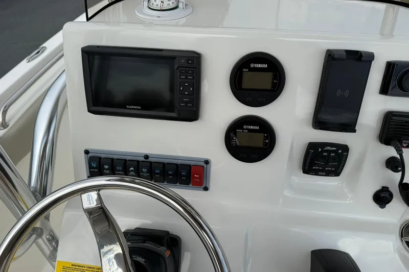 Slide: The Image of 2022 Key West 203 FS boat dashboard with Garmin display and Yamaha gauges. - 22