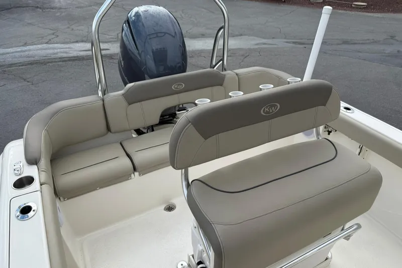 Slide: The Image of 2022 Key West 203 FS boat interior with cushioned seating and cup holders. - 23