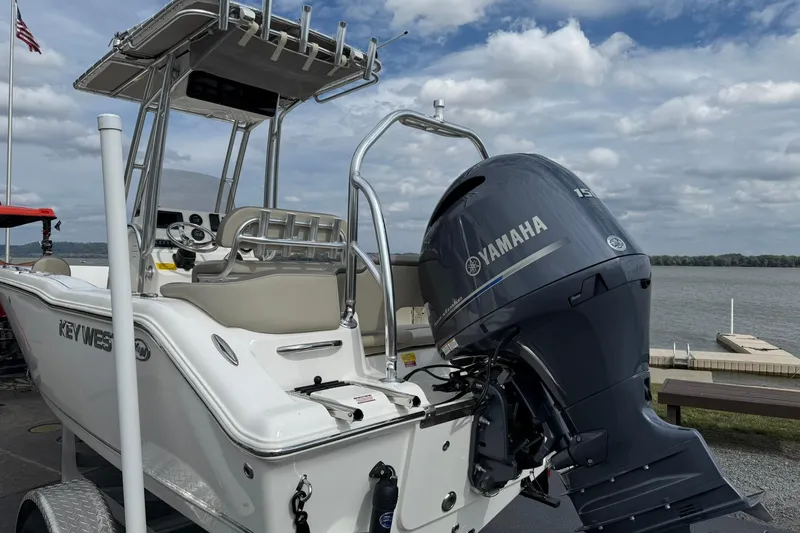 Slide: The Image of 2022 Key West 203 FS boat with Yamaha outboard motor, docked by a lake. - 3