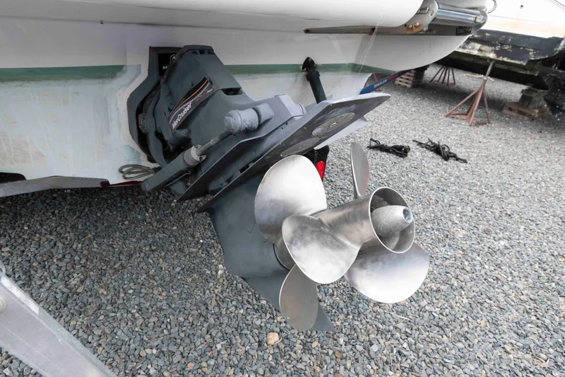 Slide: The Image of 2009 Sea Ray 250 Sundancer boat propeller and drive on gravel surface. - 14