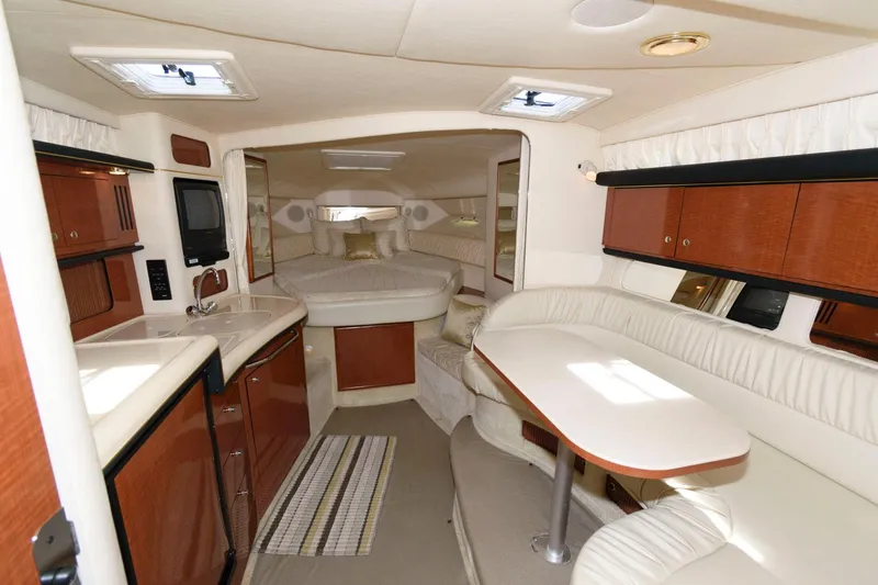 Slide: The Image of Interior of 2002 Sea Ray 340 Sundancer yacht with kitchen, seating, and bed. - 10