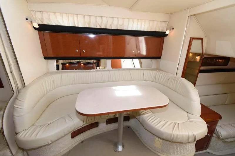 Slide: The Image of Interior of 2002 Sea Ray 340 Sundancer with curved seating and table. - 12