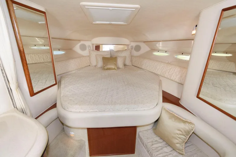 Slide: The Image of Luxurious cabin interior of 2002 Sea Ray 340 Sundancer with nautical-themed bedding. - 13