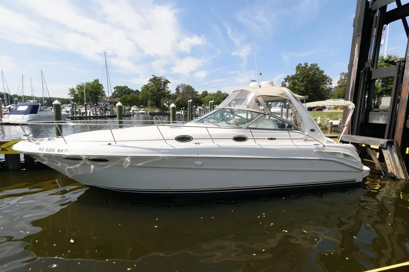 Slide: The Image of 2002 Sea Ray 340 Sundancer yacht docked at a marina. - 2