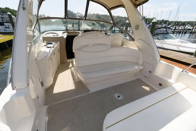 Slide: The Image of 2002 Sea Ray 340 Sundancer boat interior with white seating and helm station. - 4