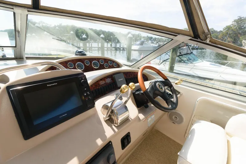 Slide: The Image of Helm of 2002 Sea Ray 340 Sundancer with navigation system and steering wheel. - 6