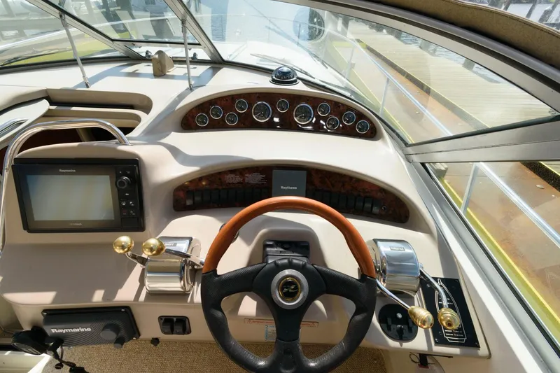 Slide: The Image of Helm of a 2002 Sea Ray 340 Sundancer with navigation equipment and steering wheel. - 7