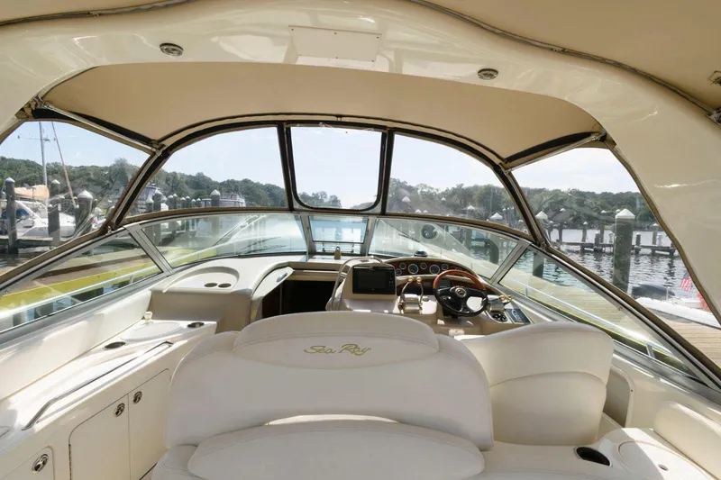 Slide: The Image of Interior cockpit of 2002 Sea Ray 340 Sundancer yacht, featuring helm and seating. - 8