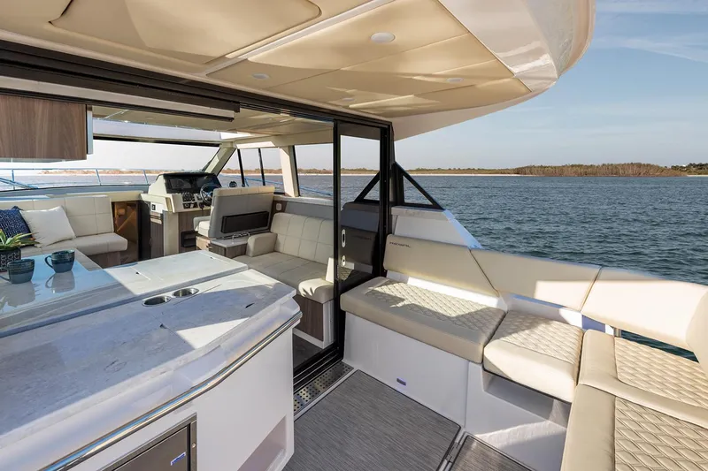 Slide: The Image of Manufacturer Provided Image: 2020 Regal 38 XO boat with beige seating on a sunny day. - 8