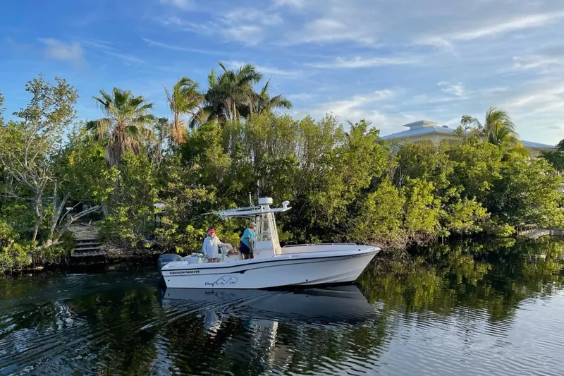 The Image of Grady-White Fisherman 222 boat on calm water near lush greenery, 2000 model. - 1