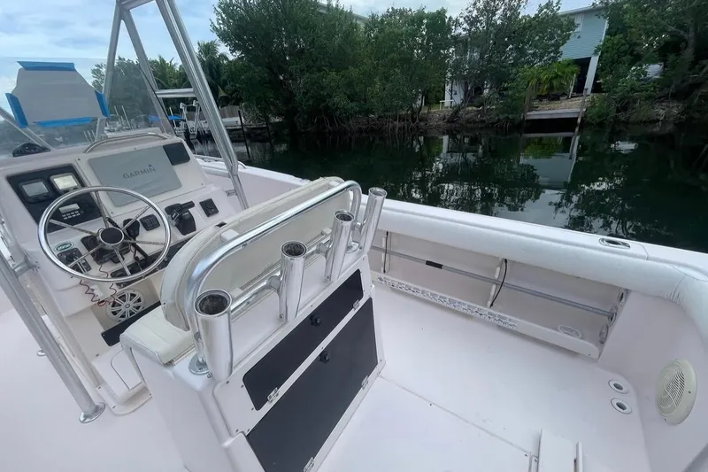 Slide: The Image of 2000 Grady-White Fisherman 222 boat interior with steering wheel and rod holders. - 6