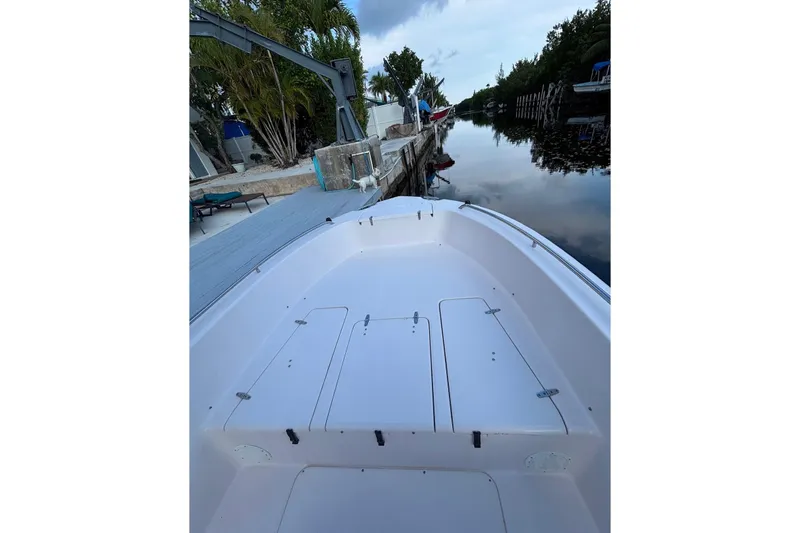 Slide: The Image of 2000 Grady-White Fisherman 222 boat docked by a serene waterfront. - 7