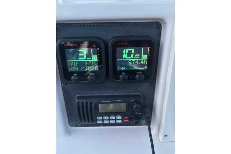 Slide: The Image of Boat dashboard with speed, fuel, and tachometer displays on a 2000 Grady-White Fisherman 222. - 9