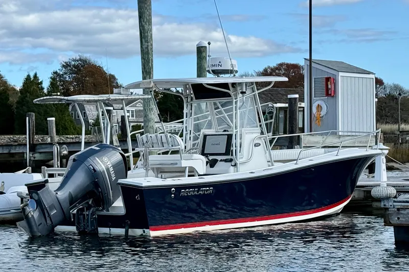 Slide: The Image of 2001 Regulator 23 Classic boat docked, featuring Yamaha outboard motor and Garmin equipment. - 2