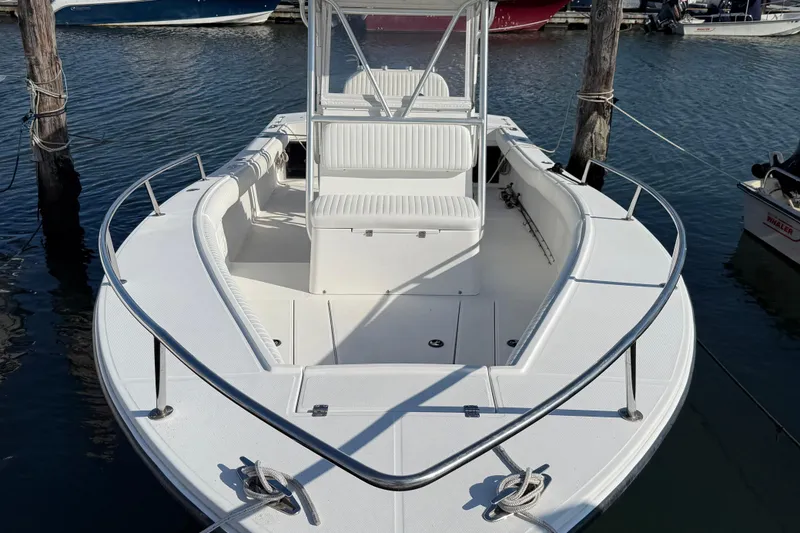 Slide: The Image of 2001 Regulator 23 Classic boat docked in marina, featuring spacious seating and sleek design. - 4