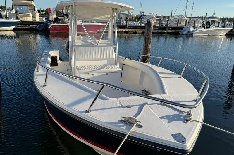 Slide: The Image of 2001 Regulator 23 Classic boat docked at marina, featuring sleek design and spacious deck. - 5