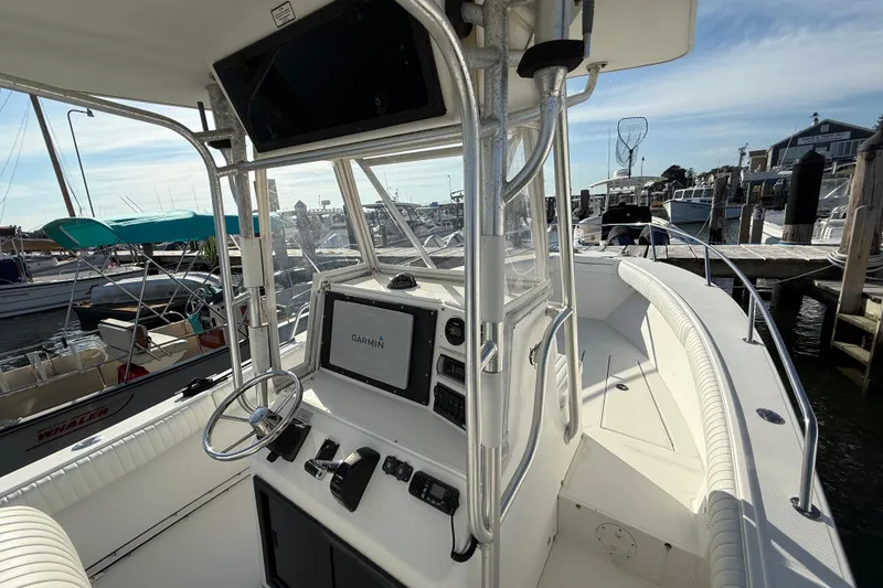 Slide: The Image of 2001 Regulator 23 Classic boat helm with Garmin navigation, docked at marina. - 6
