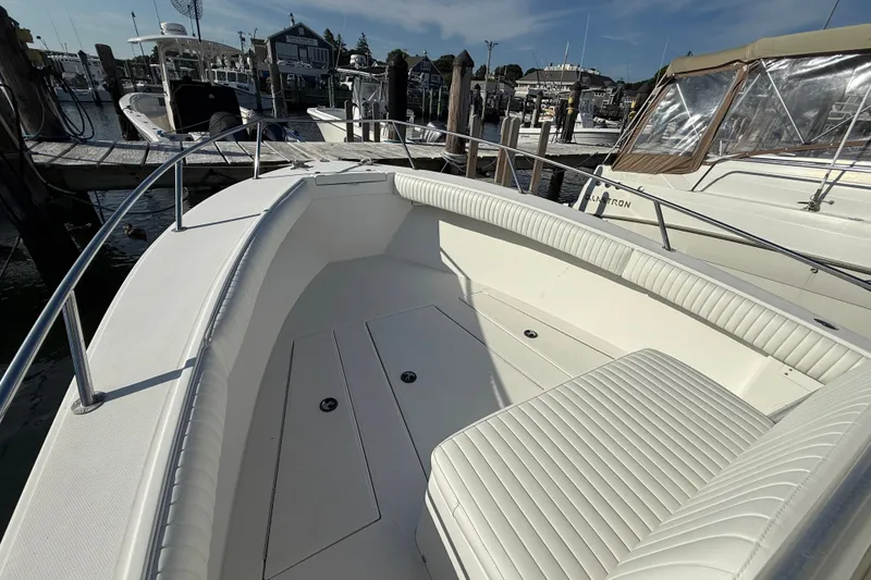 Slide: The Image of 2001 Regulator 23 Classic boat interior with white seating at a marina. - 9