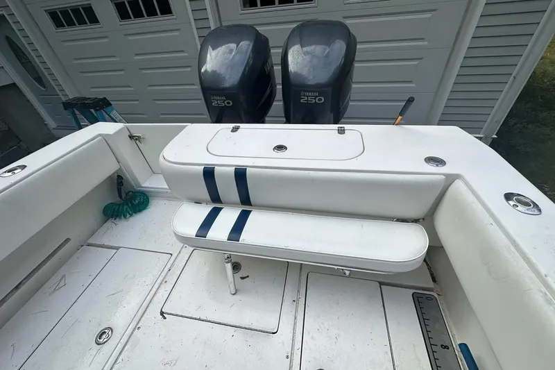 Slide: The Image of 2006 Contender 27 CC boat with Yamaha 250 engines, white seating, and storage compartments. - 12