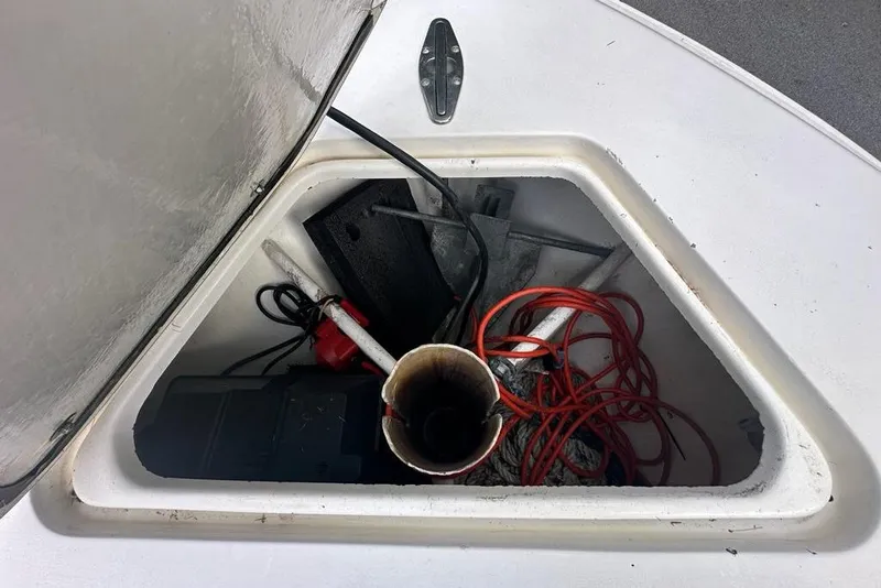 Slide: The Image of Open storage compartment on 2006 Contender 27 CC boat with various equipment inside. - 16