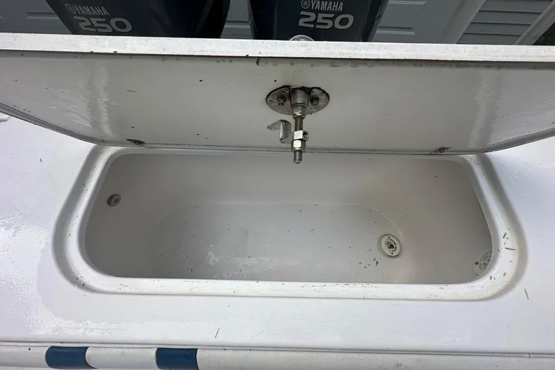 Slide: The Image of Open storage compartment on a 2006 Contender 27 CC boat with Yamaha 250 engines. - 17