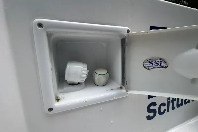 Slide: The Image of 2006 Contender 27 CC boat compartment with open hatch and SSI sticker. - 18