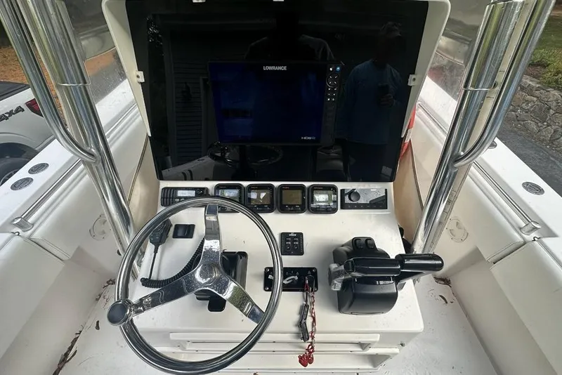 Slide: The Image of 2006 Contender 27 CC boat console with steering wheel, controls, and navigation equipment. - 3