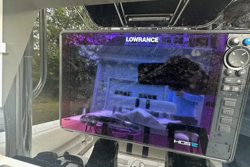 Slide: The Image of Lowrance HDS12 display on 2006 Contender 27 CC boat, reflecting surroundings. - 4