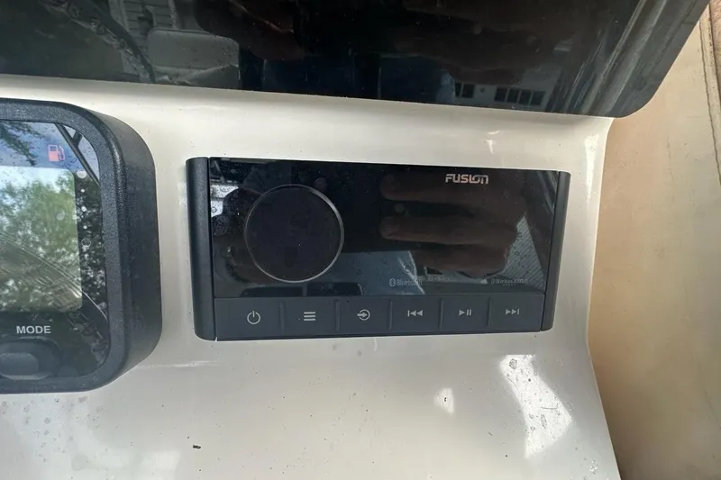 Slide: The Image of Fusion audio system on 2006 Contender 27 CC boat dashboard. - 5