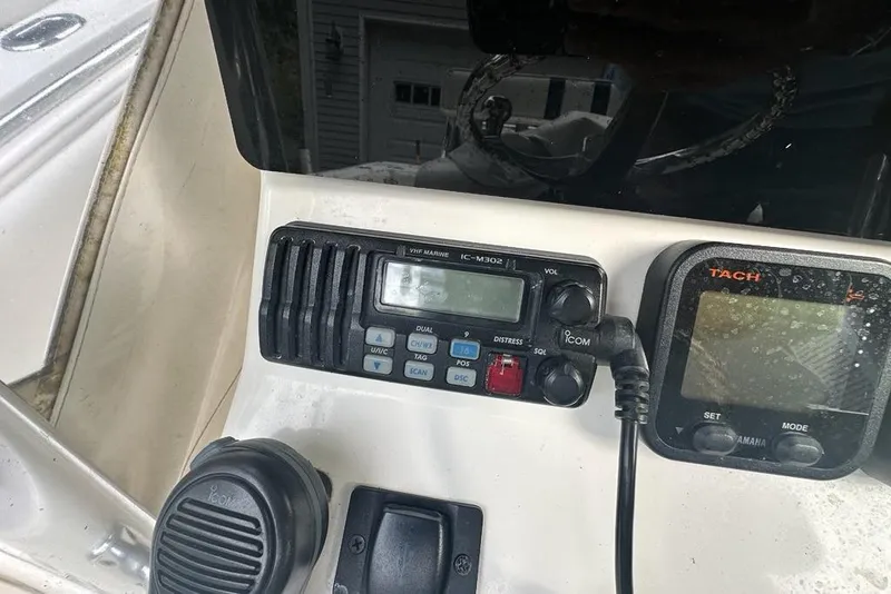 Slide: The Image of Control panel of a 2006 Contender 27 CC boat with VHF radio and tachometer. - 6