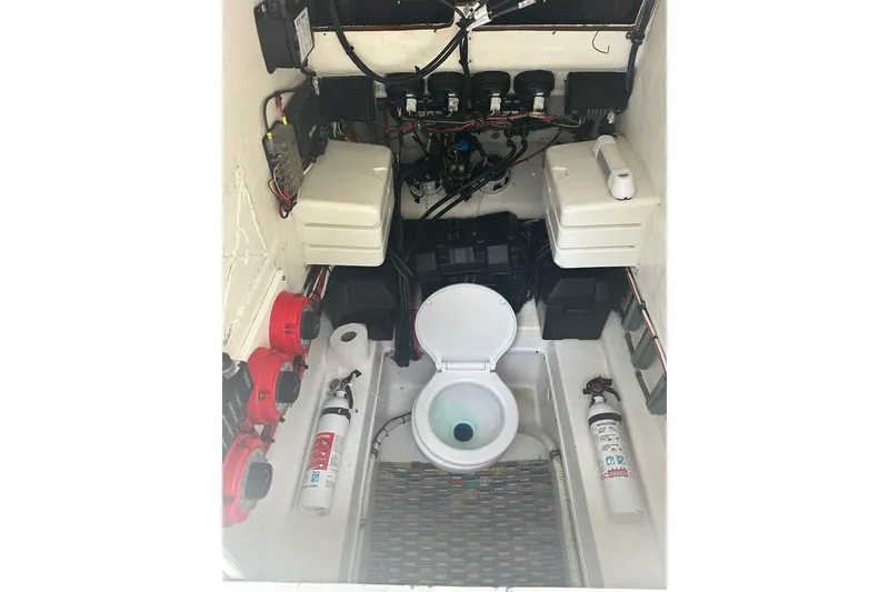 Slide: The Image of 2006 Contender 27 CC boat interior with toilet, wiring, and fire extinguishers. - 9