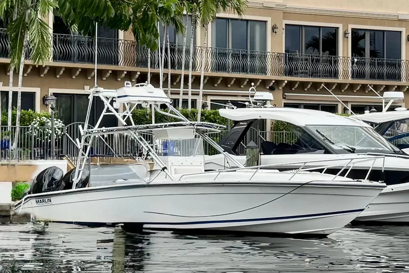 The Image of 1993 Marlin 35 CC Sportfish boat docked near waterfront building. - 0
