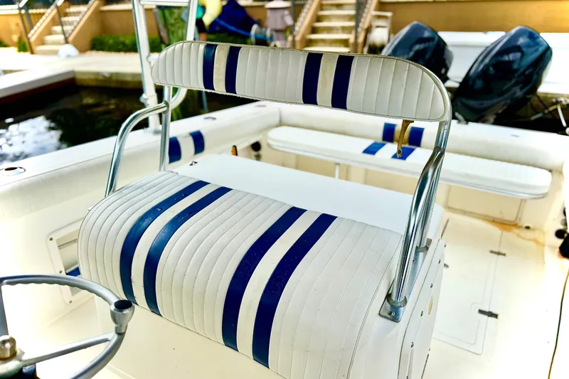 Slide: The Image of 1993 Marlin 35 CC Sportfish boat interior with striped seating and steering wheel. - 11