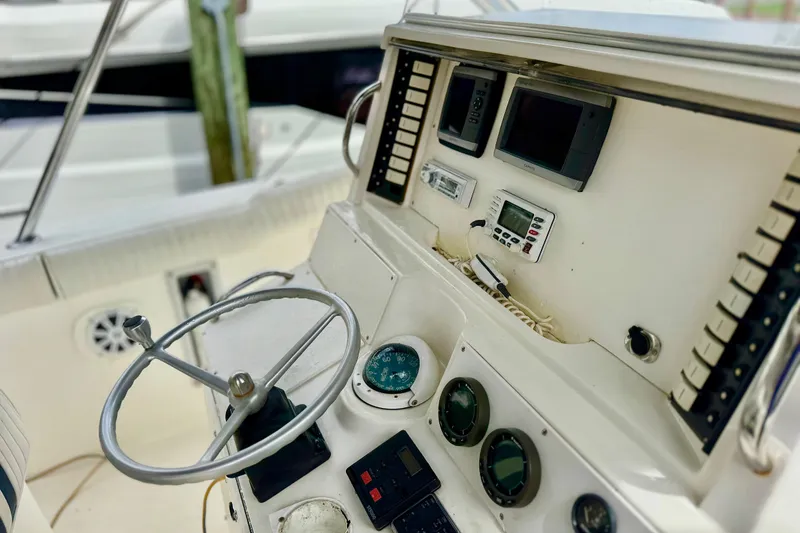 Slide: The Image of 1993 Marlin 35 CC Sportfish boat interior with striped seating and steering wheel. - 16