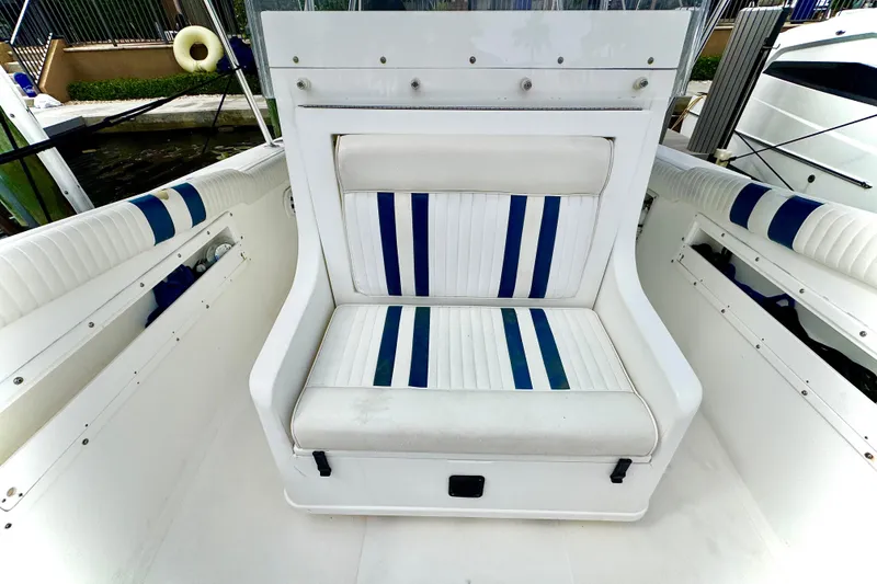 Slide: The Image of 1993 Marlin 35 CC Sportfish boat docked, surrounded by palm trees and cloudy sky. - 20