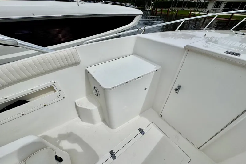 Slide: The Image of 1993 Marlin 35 CC Sportfish boat with cuddy cabin, docked near palm trees. - 33