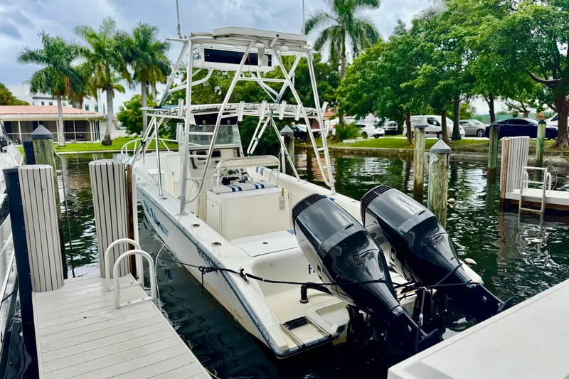 Slide: The Image of 1993 Marlin 35 CC Sportfish boat interior with striped seating and dock view. - 36