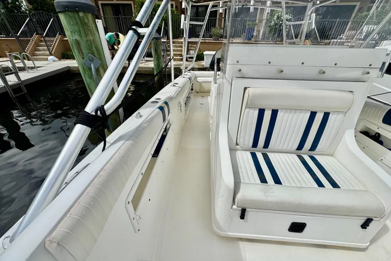 Slide: The Image of 1993 Marlin 35 CC Sportfish boat interior with white and blue striped seating. - 37