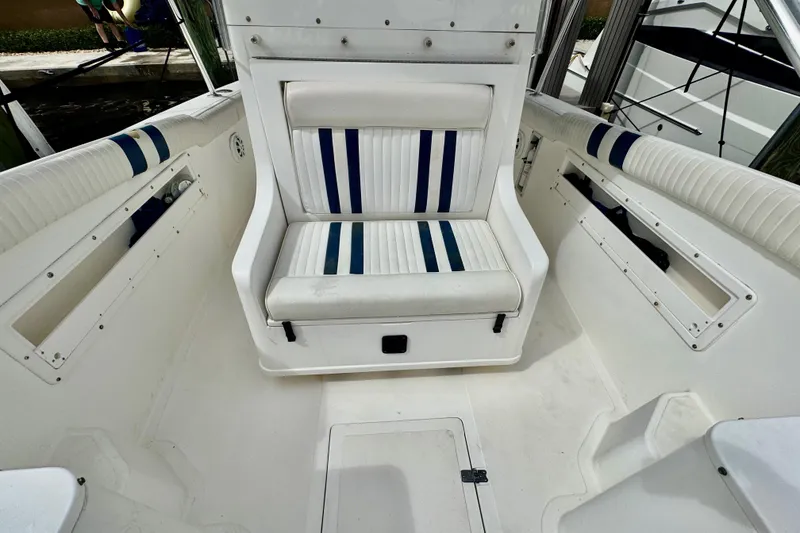 Slide: The Image of 1993 Marlin 35 CC Sportfish boat with cuddy cabin, docked near palm trees. - 38